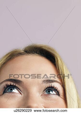 Mid adult woman looking up high section high section close-up View Large Photo Image Stock Photo - Mid adult woman looking up high section high section close-up. Fotosearch
