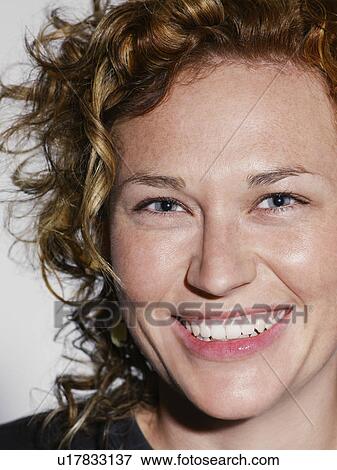 Mid adult woman smiling close-up View Large Photo Image Stock Photo - Mid adult woman smiling close-up. Fotosearch