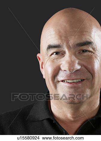 Picture - Middle-aged bald man smiling close-up. Fotosearch