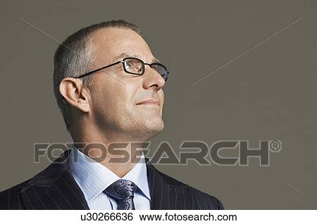 Stock Photograph - Middle-aged Businessman in glasses smiling. Fotosearch