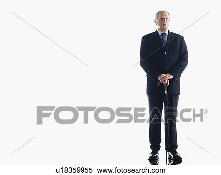Stock Photography - Middle-aged businessman leaning on umbrella. Fotosearch