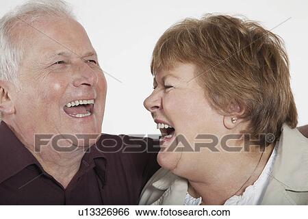 Stock Photograph - Middle-aged couple laughing close-up. Fotosearch