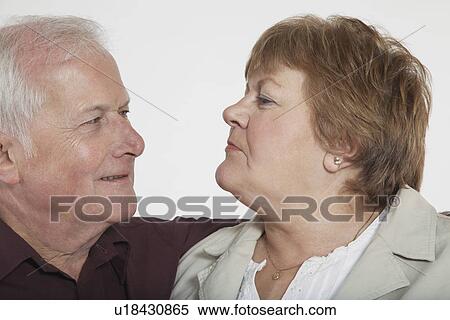 Stock Photography - Middle-aged couple looking in eyes close-up. Fotosearch