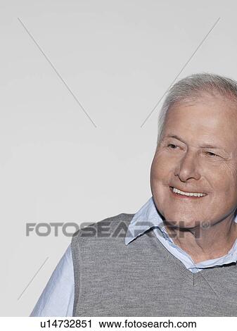 Stock Image - Middle-aged man looking away and smiling. Fotosearch