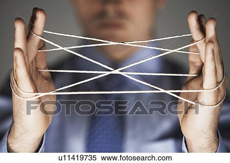 Middle aged man making cat's cradle mid section close-up View Large Photo Image Stock Photography - Middle aged man making cat's cradle mid section close-up. Fotosearch