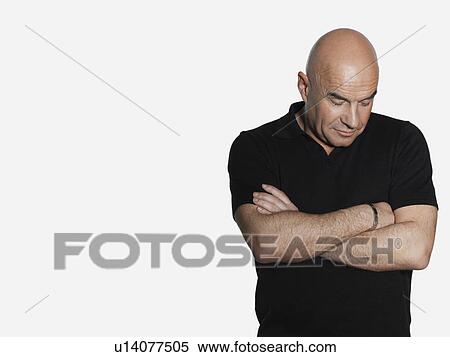 Middle-aged man standing with arms crossed View Large Photo Image Stock Photography - Middle-aged man standing with arms crossed. Fotosearch