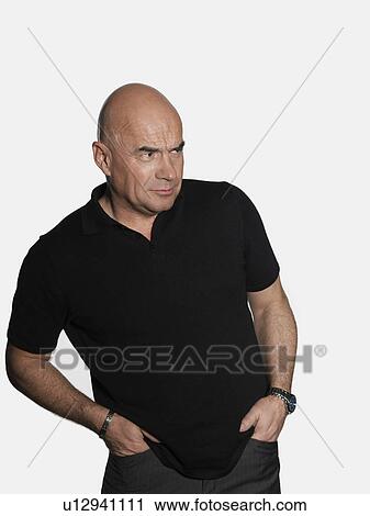 Middle-aged man standing with hands in pockets View Large Photo Image Stock Image - Middle-aged man standing with hands in pockets. Fotosearch