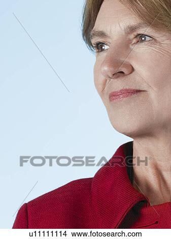 Picture - Middle-aged woman looking away and smiling close-up. Fotosearch
