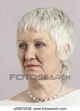 Stock Photo - Middle-aged woman looking away close-up. Fotosearch
