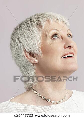 Middle-aged woman looking up and smiling close-up View Large Photo Image Stock Image - Middle-aged woman looking up and smiling close-up. Fotosearch