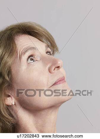 Middle-aged woman looking up close-up View Large Photo Image Stock Image - Middle-aged woman looking up close-up. Fotosearch