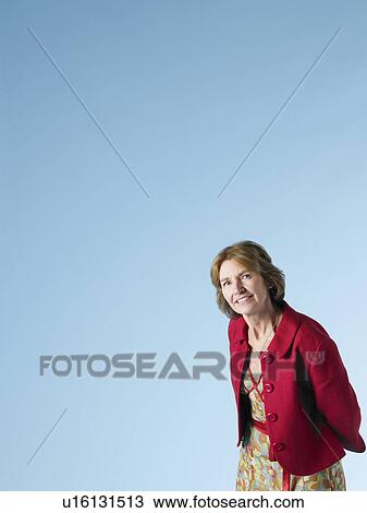Middle-aged woman on blue background View Large Photo Image Stock Image - Middle-aged woman on blue background. Fotosearch