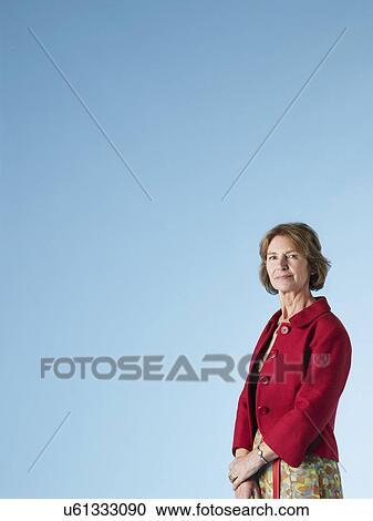 Middle-aged woman on blue background View Large Photo Image Stock Image - Middle-aged woman on blue background. Fotosearch