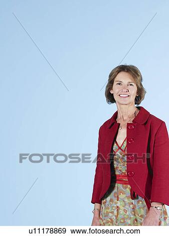 Middle-aged woman on blue background View Large Photo Image Stock Photo - Middle-aged woman on blue background. Fotosearch