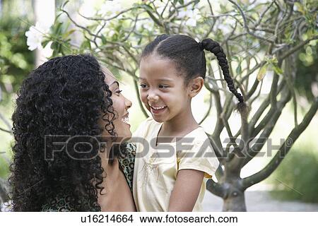 Mother and daughter (5-6 years) in garden View Large Photo Image Picture - Mother and daughter (5-6 years) in garden. Fotosearch