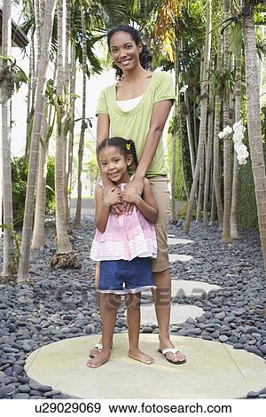 Mother and daughter (5-6 years) standing on path View Large Photo Image Stock Photo - Mother and daughter (5-6 years) standing on path. Fotosearch
