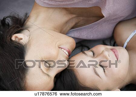 Mother and daughter resting together head and shoulders close up View Large Photo Image Stock Photograph - Mother and daughter resting together head and shoulders close up. Fotosearch