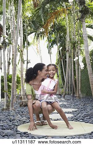 Mother crouching with daughter (5-6 years) on path View Large Photo Image Stock Photo - Mother crouching with daughter (5-6 years) on path. Fotosearch