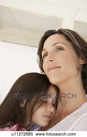 Mother cuddling daughter head and shoulders View Large Photo Image Stock Photography - Mother cuddling daughter head and shoulders. Fotosearch