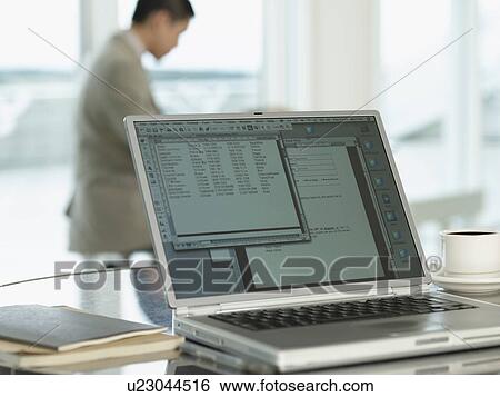 Stock Photograph - Open laptop laying on tabletop. Fotosearch
