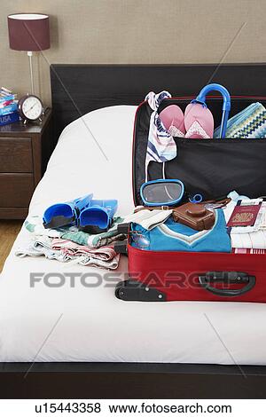 Open suitcase on bed elevated view View Large Photo Image Stock Photo - Open suitcase on bed elevated view. Fotosearch
