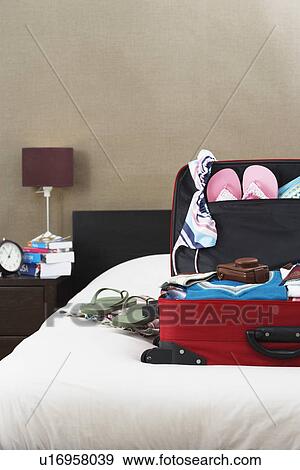 Open suitcase on bed View Large Photo Image Stock Photo - Open suitcase on bed. Fotosearch