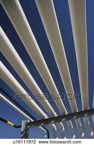 Stock Image - Parallel pipes outside. Fotosearch