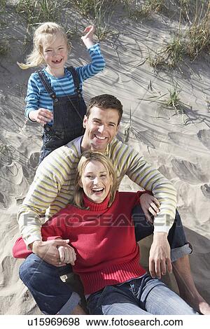 Parents with daughter (5-6) on beach portrait View Large Photo Image Stock Photo - Parents with daughter (5-6) on beach portrait. Fotosearch