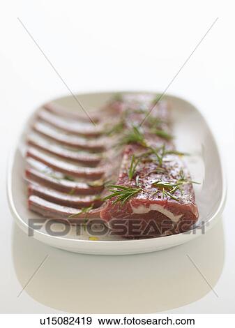 Plate of Fresh raw Ribs with rosemary sprinkled on it View Large Photo Image Stock Photo - Plate of Fresh raw Ribs with rosemary sprinkled on it. Fotosearch