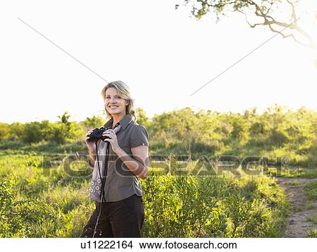 Portrait of adult woman holding binoculars View Large Photo Image Picture - Portrait of adult woman holding binoculars. Fotosearch