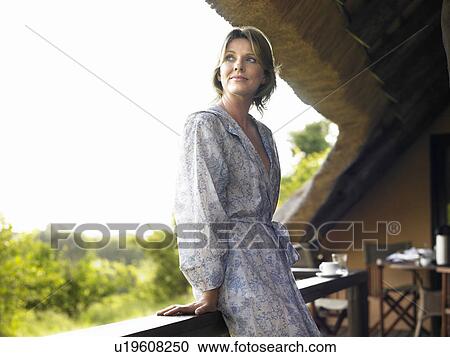 Portrait of adult woman on terrace in bathrobe looking over shoulder View Large Photo Image Stock Image - Portrait of adult woman on terrace in bathrobe looking over shoulder. Fotosearch