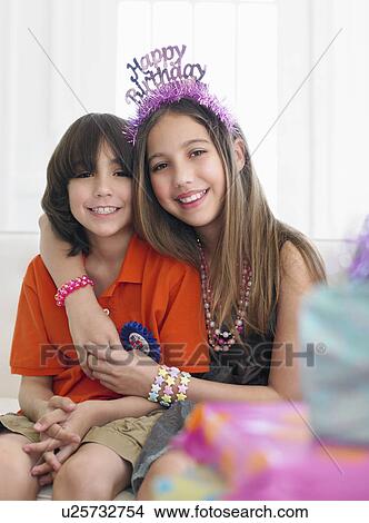 Picture - Portrait of boy and girl (10-12) at birthday party. Fotosearch