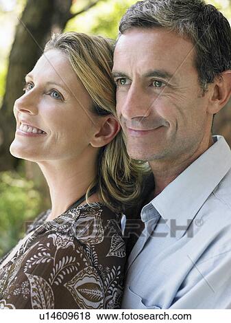 Stock Photo - Portrait of couple embracing and smiling outdoors. Fotosearch