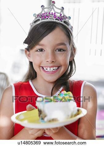 Portrait of girl (7-9) with piece of birthday cake on plate smiling View Large Photo Image Stock Photo - Portrait of girl (7-9) with piece of birthday cake on plate smiling. Fotosearch