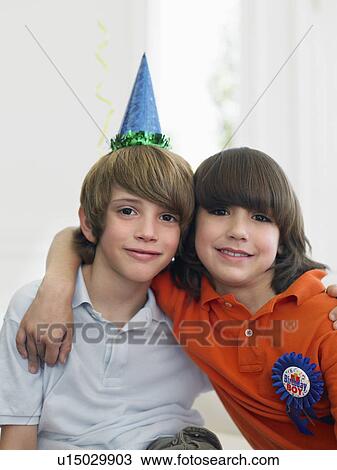 Portrait of two boys (10-12) at birthday party View Large Photo Image Stock Image - Portrait of two boys (10-12) at birthday party. Fotosearch