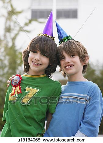 Portrait of two boys (10-12) in party hats close-up View Large Photo Image Stock Photography - Portrait of two boys (10-12) in party hats close-up. Fotosearch