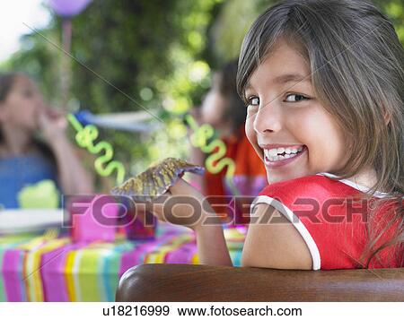 Portrait of young girl (10-12) at birthday party looking over shoulder View Large Photo Image Stock Photo - Portrait of young girl (10-12) at birthday party looking over shoulder. Fotosearch