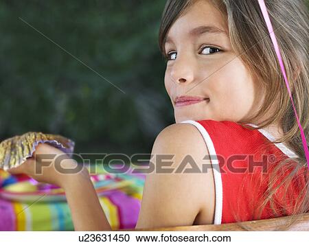 Portrait of young girl (10-12) looking over shoulder close-up View Large Photo Image Stock Image - Portrait of young girl (10-12) looking over shoulder close-up. Fotosearch