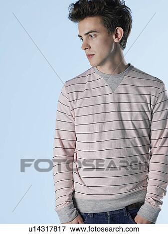 Stock Photo - Portrait of young man with hands in pockets. Fotosearch
