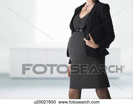 Pregnant businesswoman mid section View Large Photo Image Stock Image - Pregnant businesswoman mid section. Fotosearch