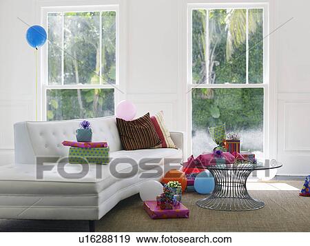 Stock Photo - Presents and balloons in empty living room. Fotosearch