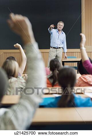 Stock Image - Professor picking out student for answer. Fotosearch