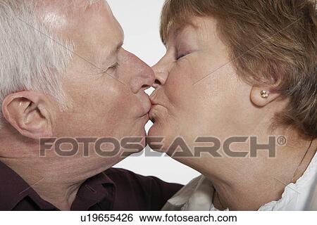 Profile of middle-aged couple kissing close-up View Large Photo Image Stock Photograph - Profile of middle-aged couple kissing close-up. Fotosearch