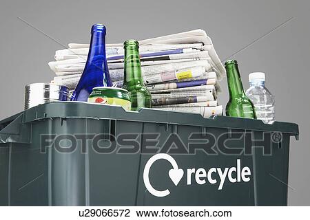 Recycling bin filled with waste paper and bottles close-up View Large Photo Image Stock Image - Recycling bin filled with waste paper and bottles close-up. Fotosearch