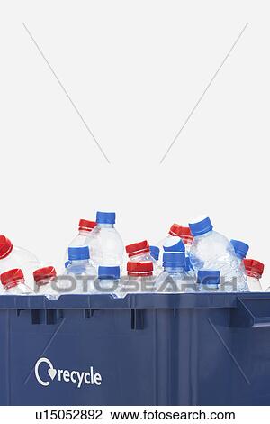 Stock Image - Recycling container filled with empty plastic bottles. Fotosearch