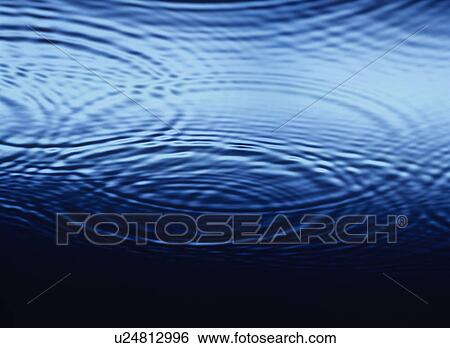 Stock Photograph - Ripples overlapping on Water close-up. Fotosearch