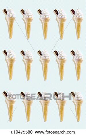 Stock Image - Rows of icecreams on colored background studio shot. Fotosearch