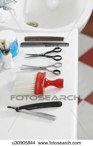 Scissors combs razor and brush on counter in barber shop View Large Photo Image Picture - Scissors combs razor and brush on counter in barber shop. Fotosearch