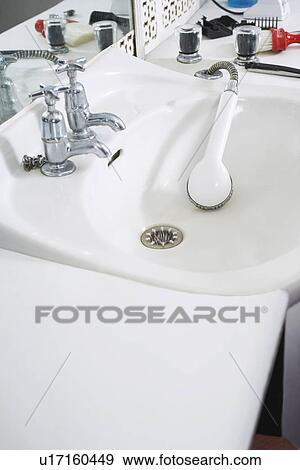 Stock Photo - Shower head in sink at barber shop. Fotosearch