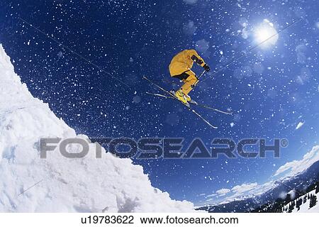 Skier in mid-air above snow on ski Slopes View Large Photo Image Stock Image - Skier in mid-air above snow on ski Slopes. Fotosearch